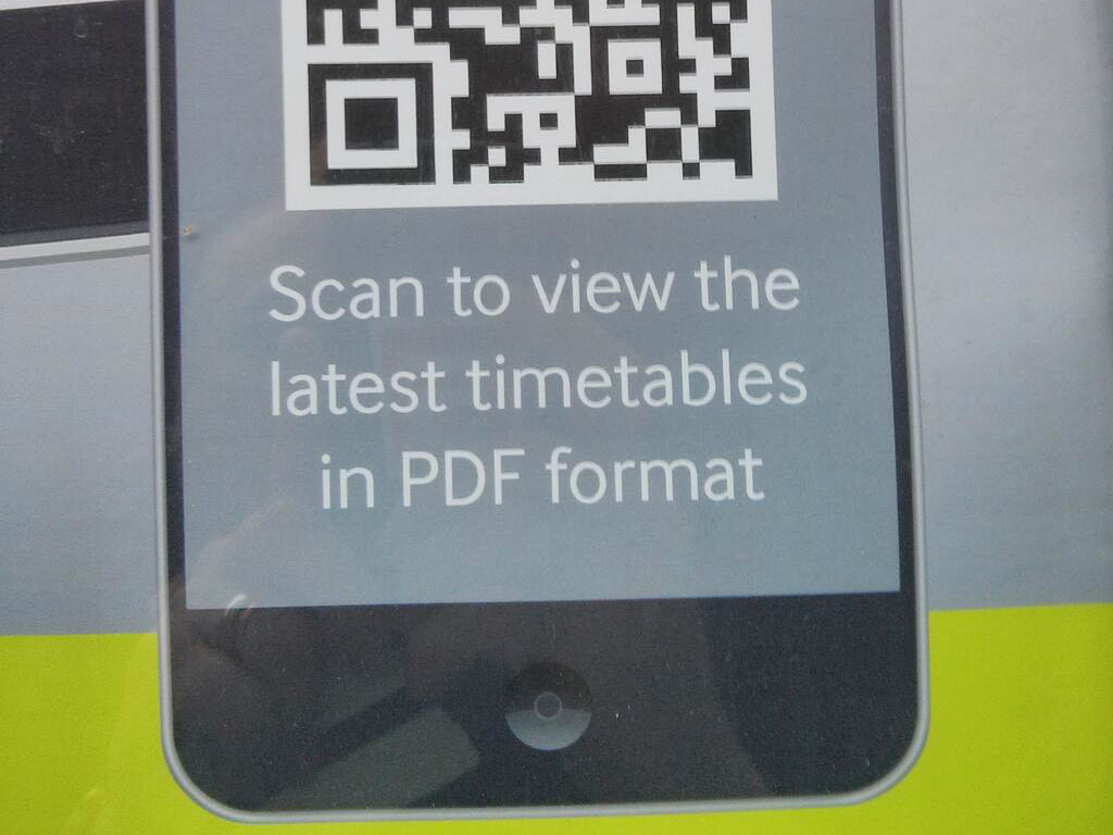 advert: photo of phone with QR code and text 'scan to download timetables in PDF format